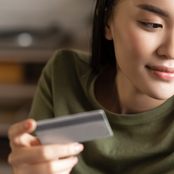 Portrait of two women, senior and young using laptop and credit card