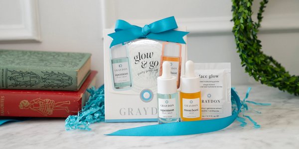 a photo of the graydon skincare glow and go party prep set on a bathroom counter. the set includes a 10ml supermoon serum, a 10ml moon boost, and a 5ml face glow